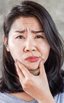 Patient in Sandown holding their jaw