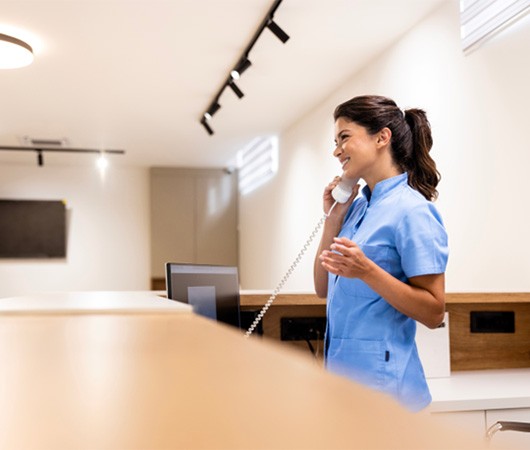 Dental receptionist on phone