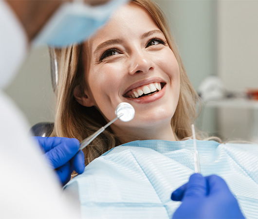 Doctor Berkal talking to patient in Derry dental office