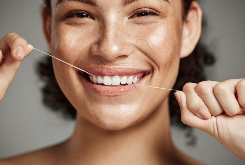 smiling woman flossing 